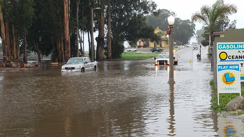 Vehicles navigating through flooding in Oceano, CA, January 2016