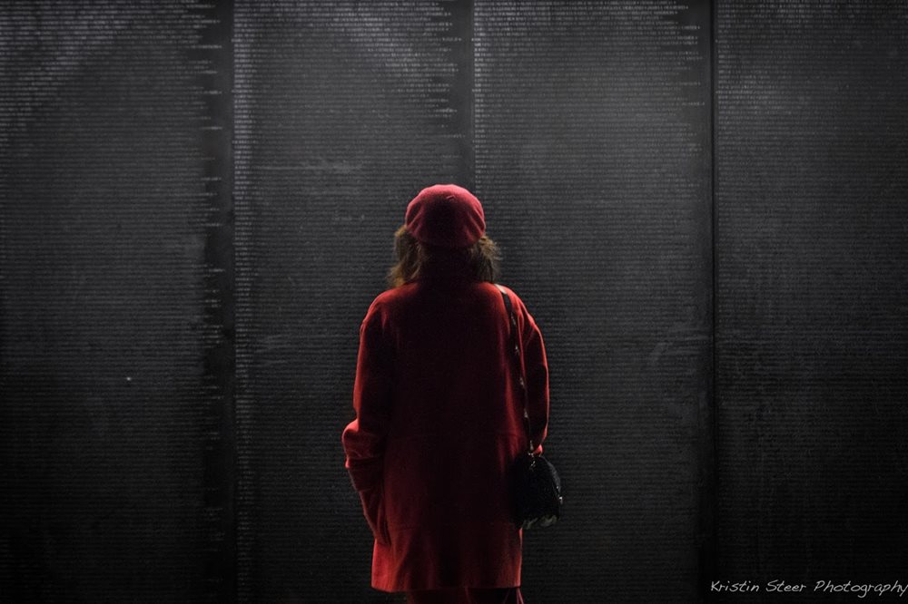 Person standing in front of the Wall That Heals