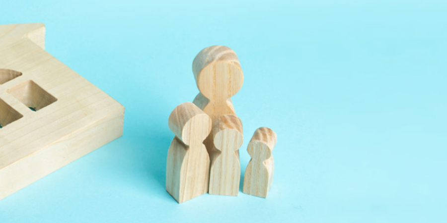 Wooden blocks in the shape of people and a house