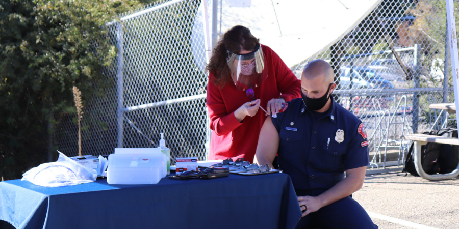 Alec Flatos, Fire Engineer and Paramedic for the San Luis Obispo Fire Department, receives the COVID-19 vaccine.