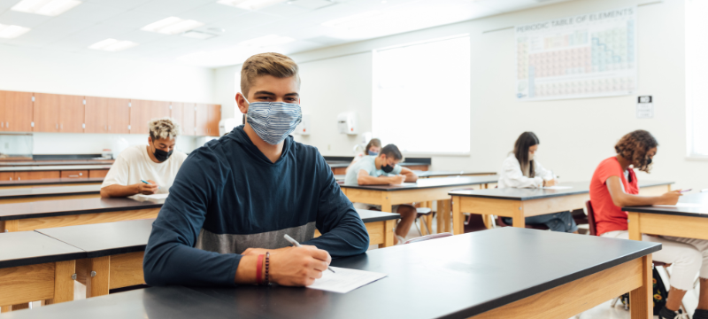 Teens wearing face coverings in the classroom. Click to view article, Public Health Department Offers Back-to-School COVID-19 Safety Tips