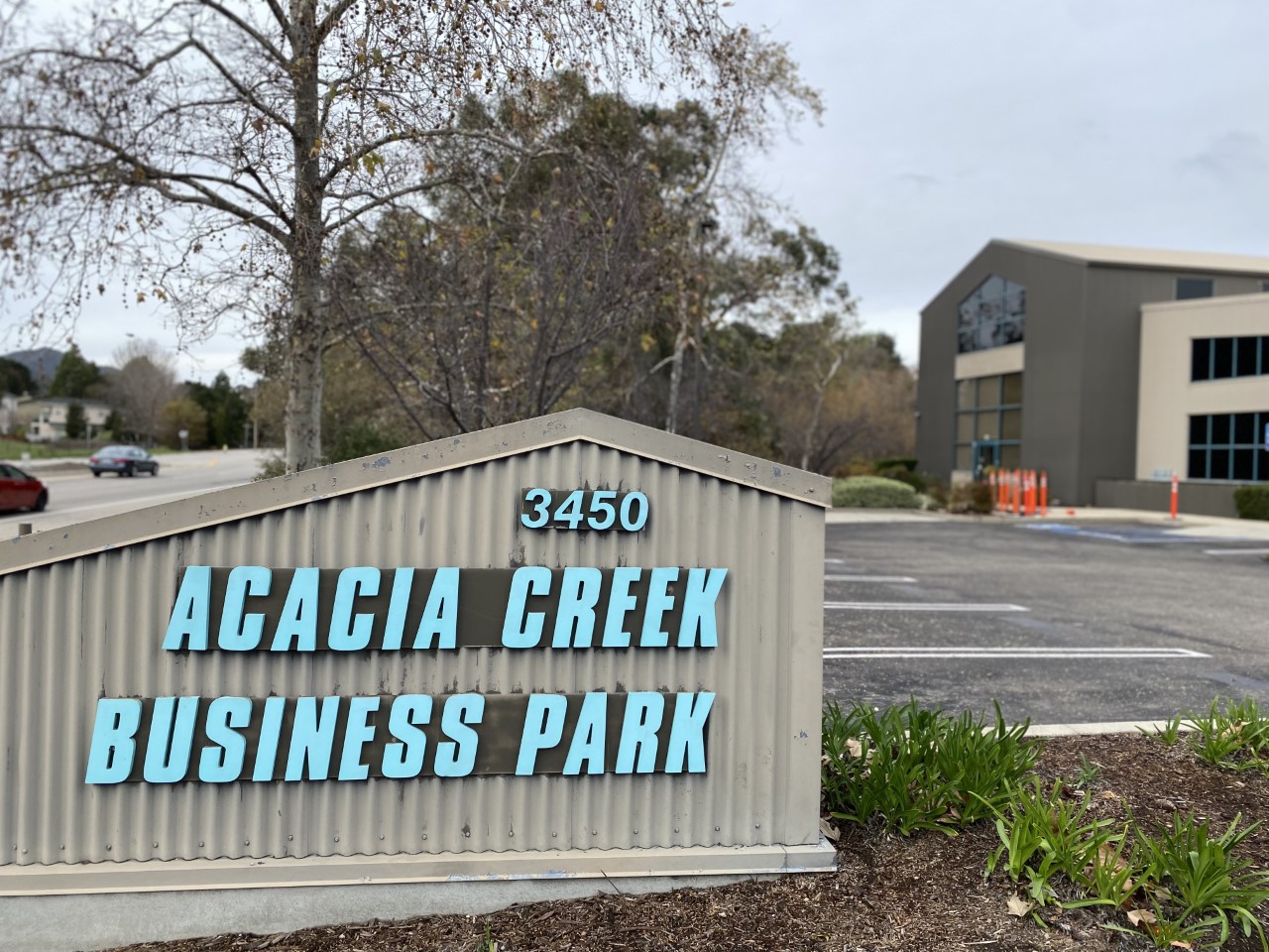 The Acacia Creek Business Park from 3450 Broad Street building with grey and teal metal panels.