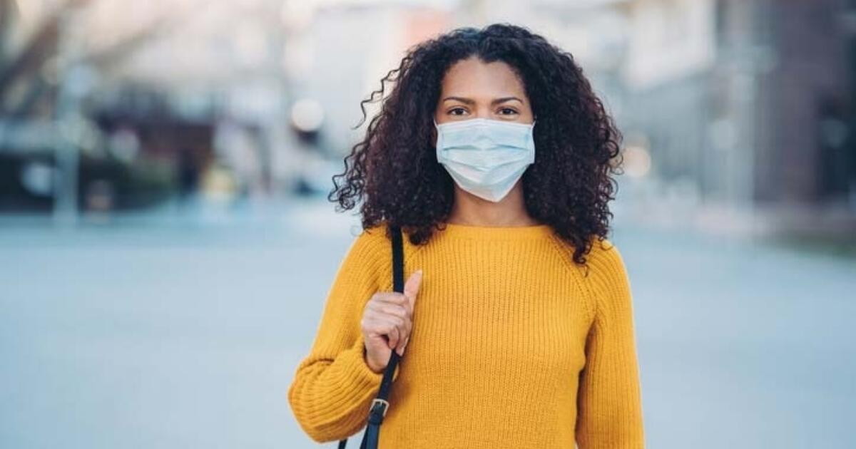 Person wearing surgical mask Click to view article, Updated State and Local Guidance Shortens COVID-19 Isolation Period to Five Days
