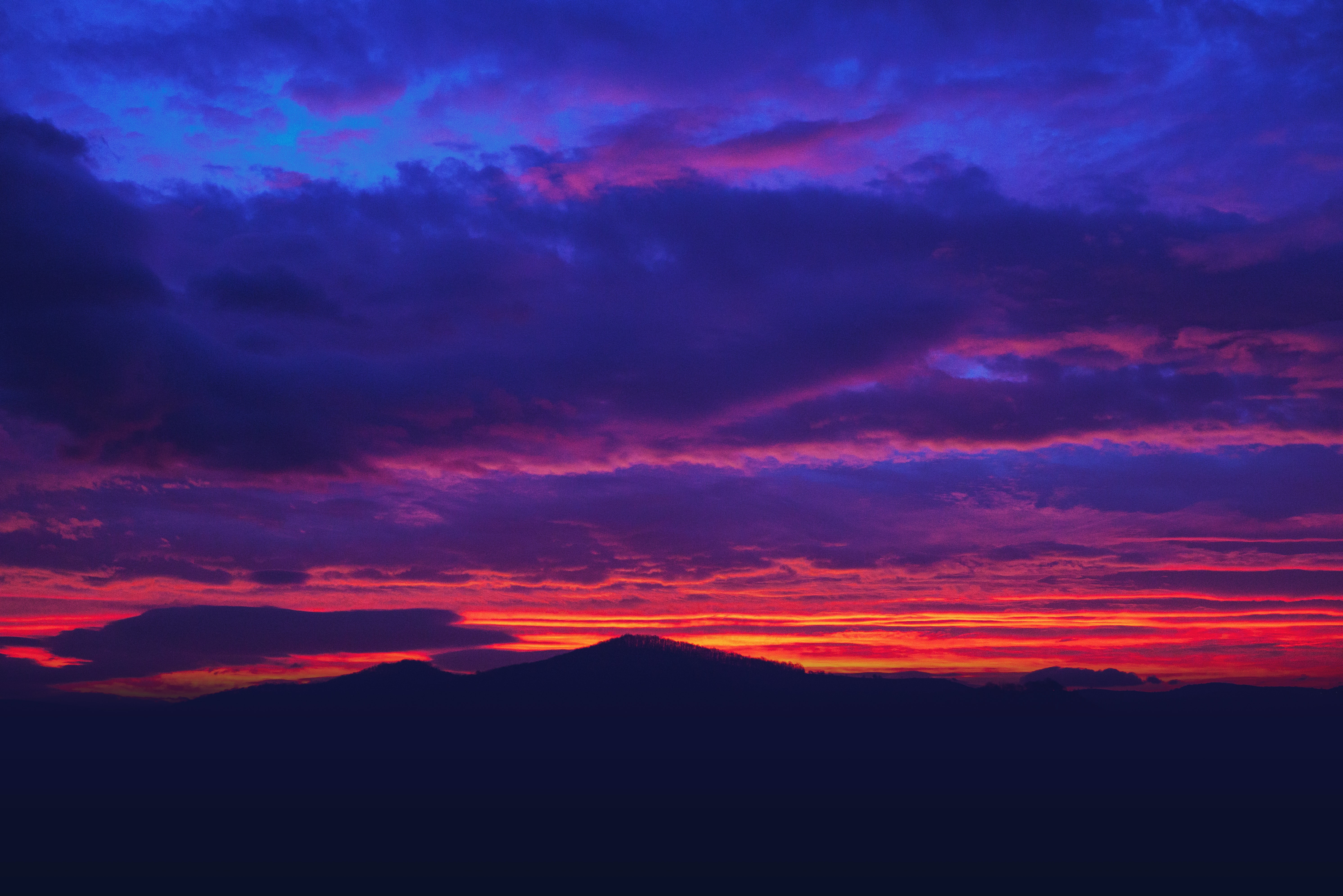 Blue and pink sunset over hills