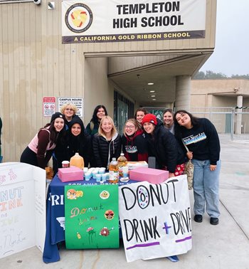 Group of students holding signs that read "donut drink and drive".