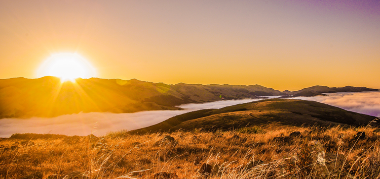 sunset over rolling hills. Click to view article, Steps to Take if You're Worried About Someone's Mental Health
