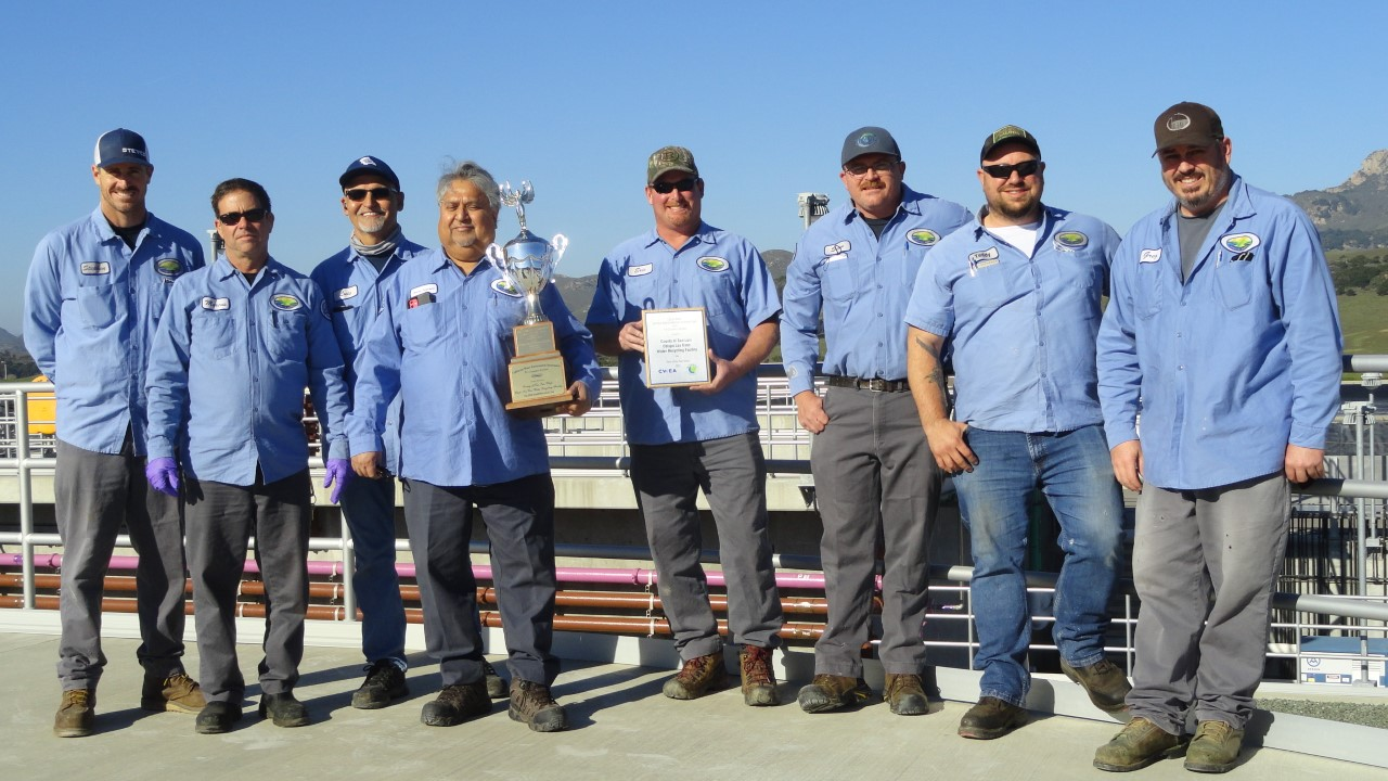 Los Osos Staff holding the CWEA Small Plant of the Year Trophy and plaque