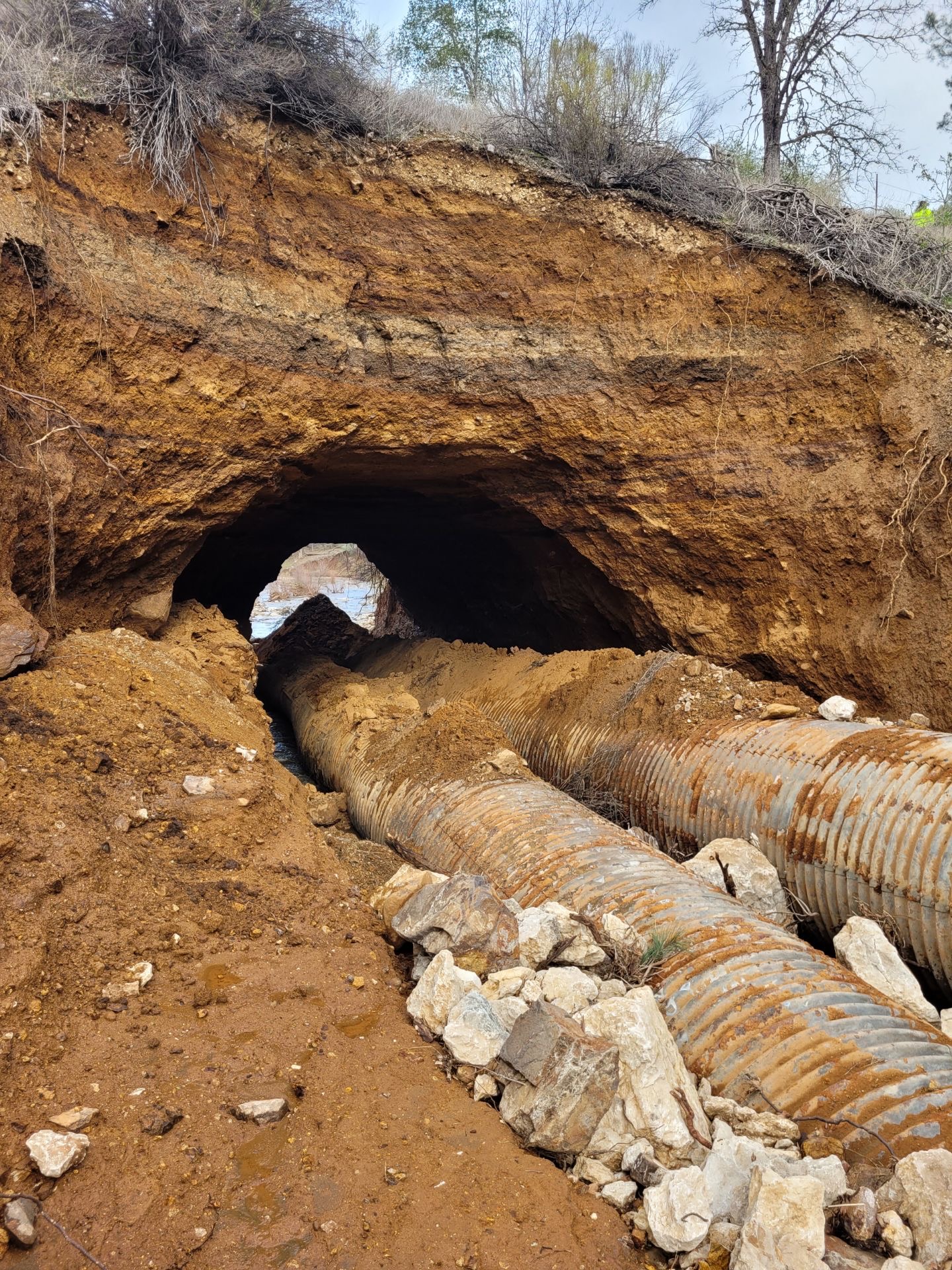 Soil between road and culverts eroded by storm water