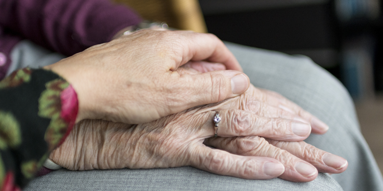 Woman comforting an elderly person. Click to view article, A Message to Behavioral Health Clients and Families