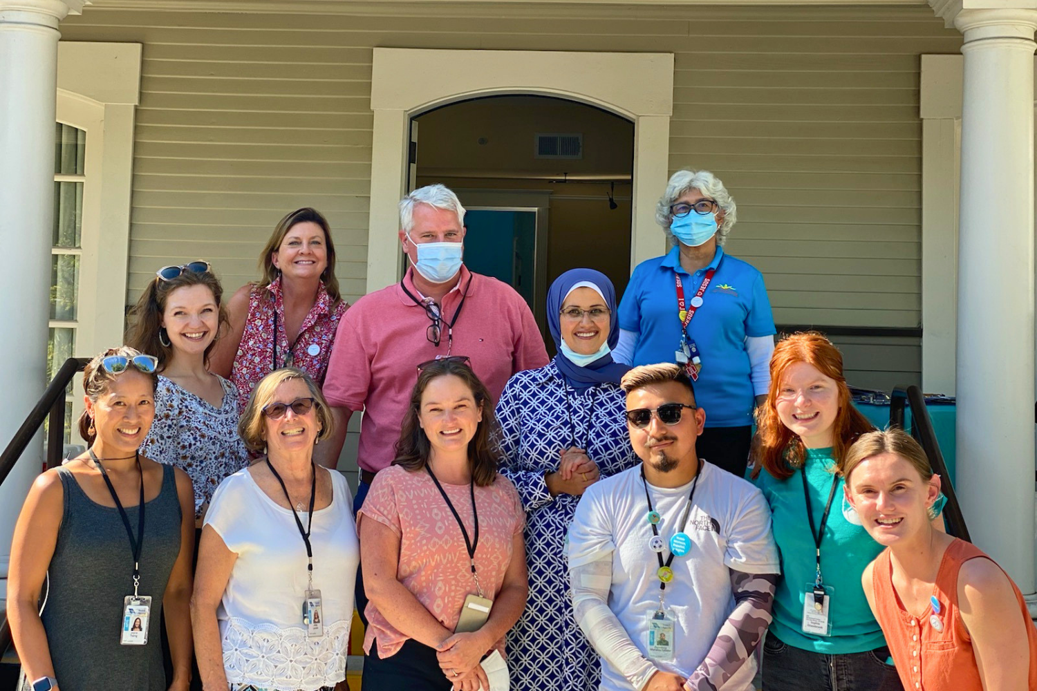 Public health staff wearing lanyards, pins, and face coverings