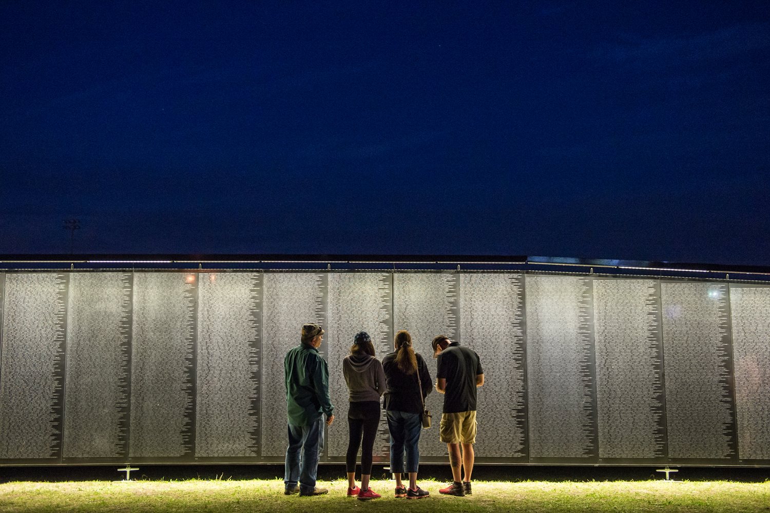People standing in front of the Wall That Heals
