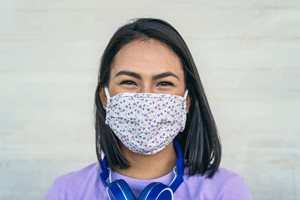 Photo of smiling woman in mask