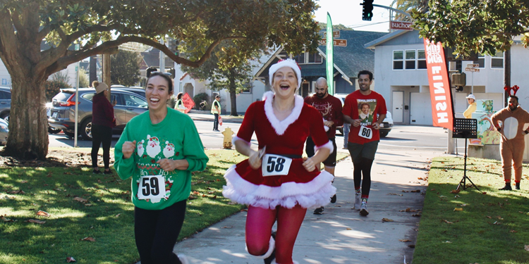 Participants crossing the finish line at Reindeer Run.  Click to view article, Community Members Invited to Dash and Prance at SLO’s 5k Reindeer Run